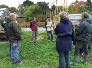 The group gathers around Ralf Roessner (in hat) to hear more about the light root.